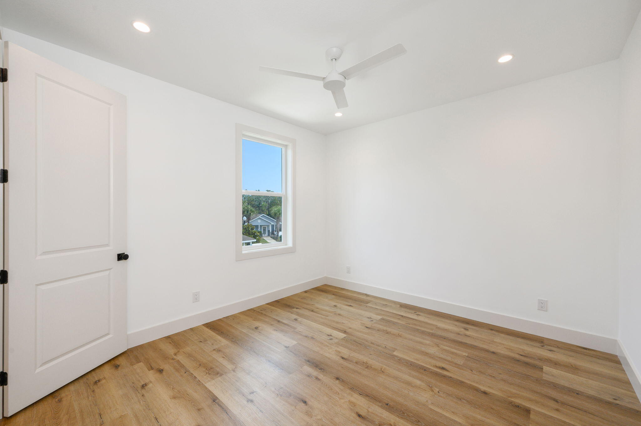 114 Enchanted Way Santa Rosa Beach, FL 32459 - Photo 21 of 33 an empty room with wooden floor and windows