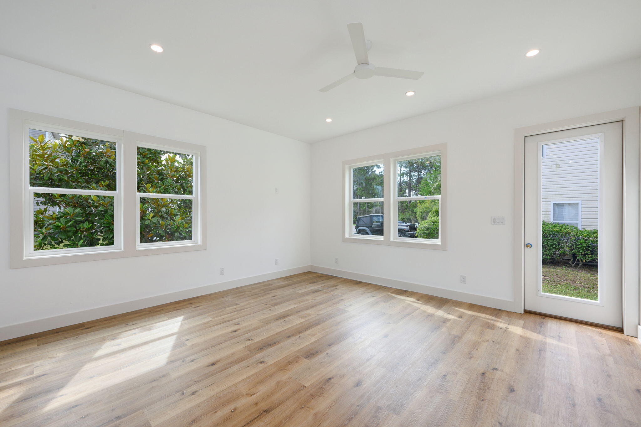 114 Enchanted Way Santa Rosa Beach, FL 32459 - Photo 5 of 33 an empty room with wooden floor and windows