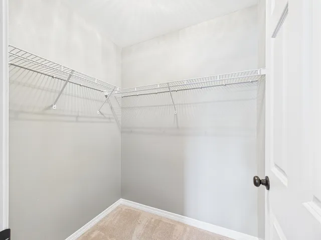 a spacious bathroom with a granite countertop sink a toilet and a mirror