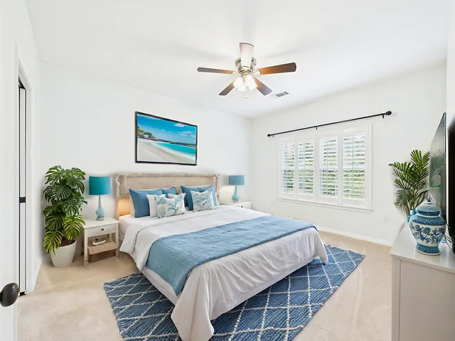 a bedroom with a bed couch and window