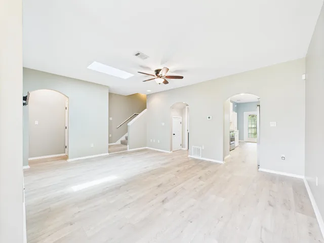 a view of an empty room with a ceiling fan