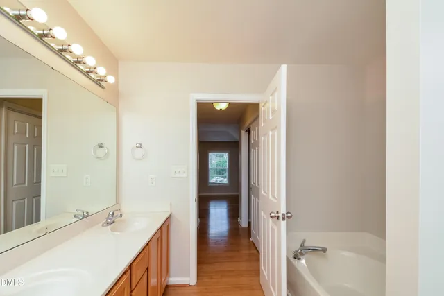 a en suite bathroom with a sink a large mirror and vanity