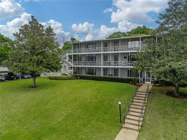 a view of a house with a backyard