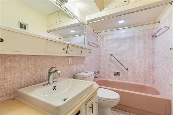 a bathroom with a sink a toilet and a bathtub