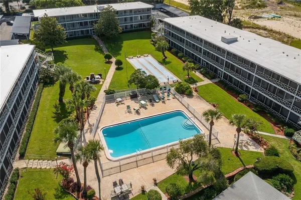 an aerial view of a house with a garden and swimming pool