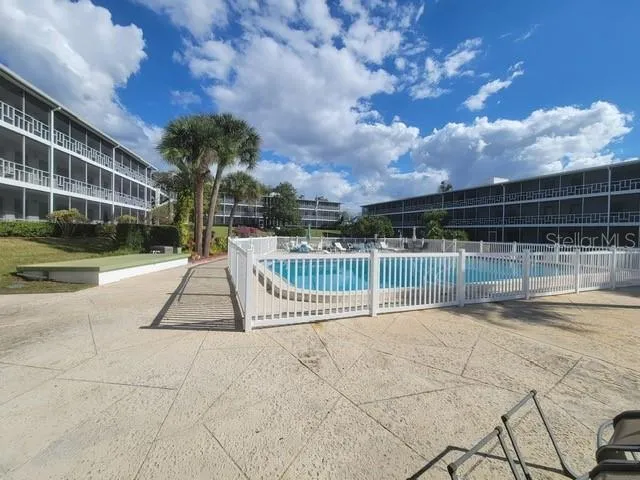 an aerial view of a house with a garden and swimming pool