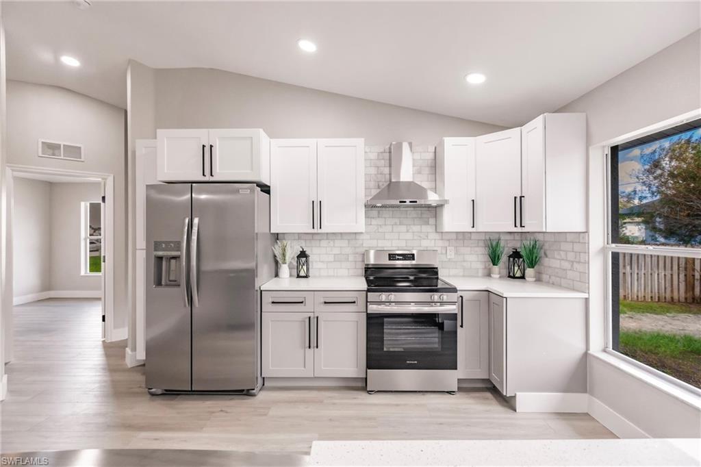 18289 Hepatica Road Fort Myers, FL 33967 - Photo 13 of 45 a kitchen with stainless steel appliances a refrigerator sink and stove