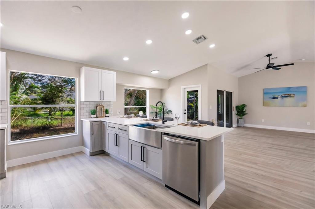 18289 Hepatica Road Fort Myers, FL 33967 - Photo 14 of 45 a kitchen with sink stove and refrigerator