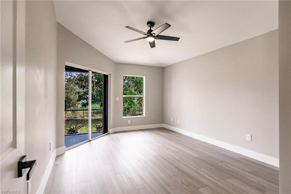 18289 Hepatica Road Fort Myers, FL 33967 - Photo 18 of 45 wooden floor in an empty room with a window