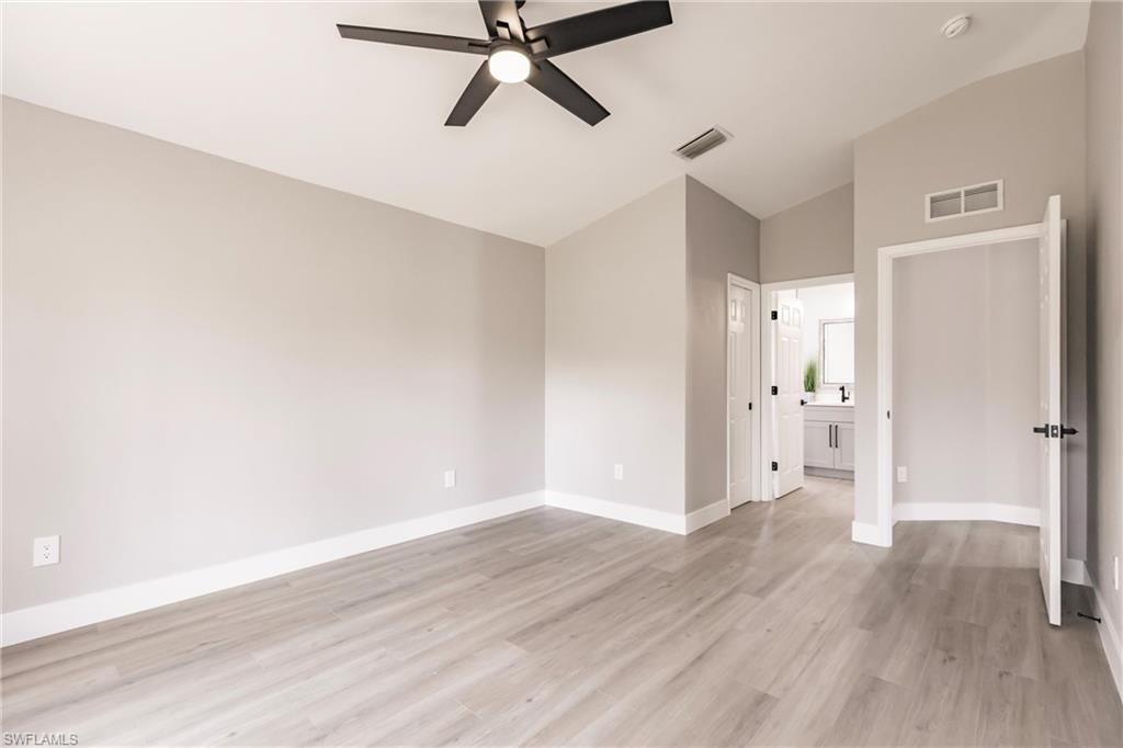 18289 Hepatica Road Fort Myers, FL 33967 - Photo 19 of 45 a view of a hallway with wooden floor and a ceiling fan