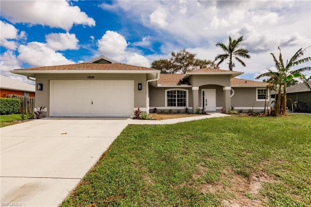 18289 Hepatica Road Fort Myers, FL 33967 - Photo 2 of 45 a front view of a house with a garden and plants