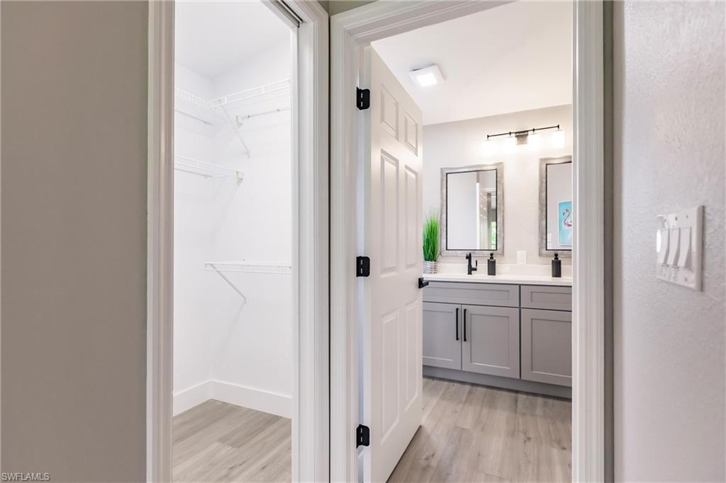 18289 Hepatica Road Fort Myers, FL 33967 - Photo 22 of 45 a bathroom with a sink and mirror with shower