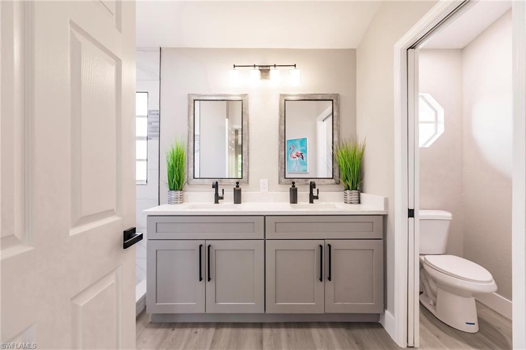 18289 Hepatica Road Fort Myers, FL 33967 - Photo 24 of 45 a bathroom with a toilet a sink and a mirror