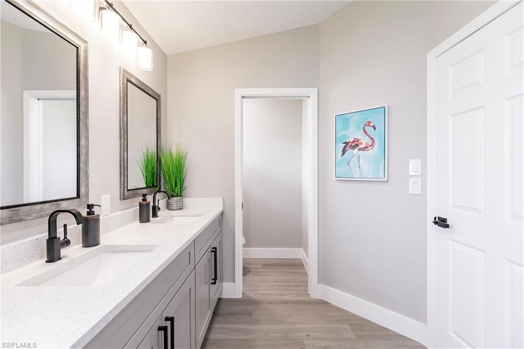 18289 Hepatica Road Fort Myers, FL 33967 - Photo 27 of 45 a bathroom with a double vanity sink and a mirror