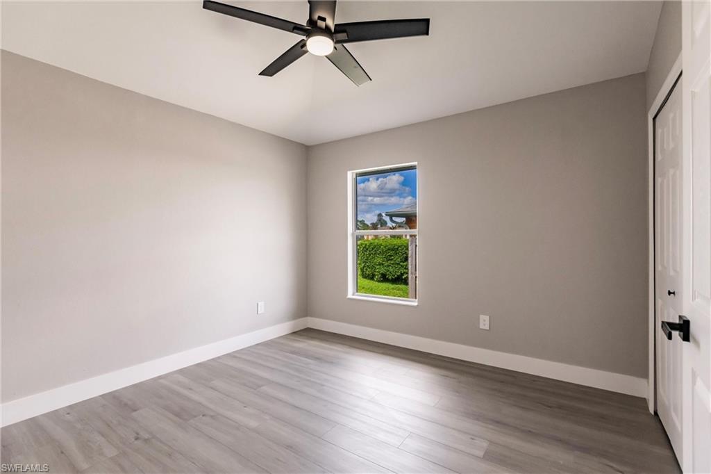 18289 Hepatica Road Fort Myers, FL 33967 - Photo 28 of 45 wooden floor in an empty room with a window
