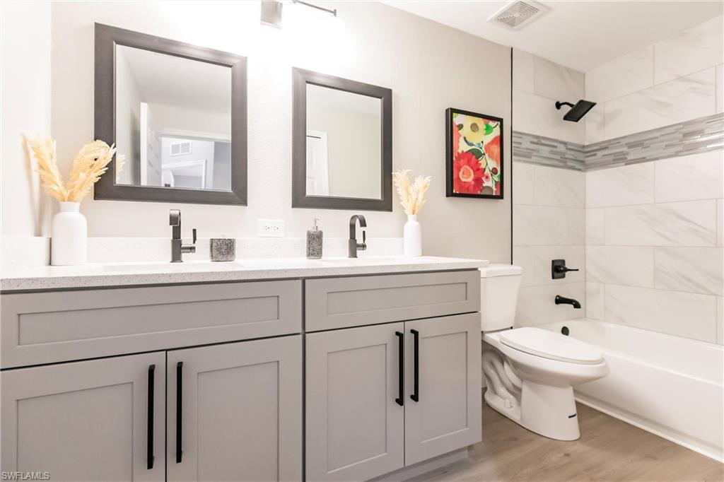 18289 Hepatica Road Fort Myers, FL 33967 - Photo 30 of 45 a bathroom with a toilet a sink and a bathtub
