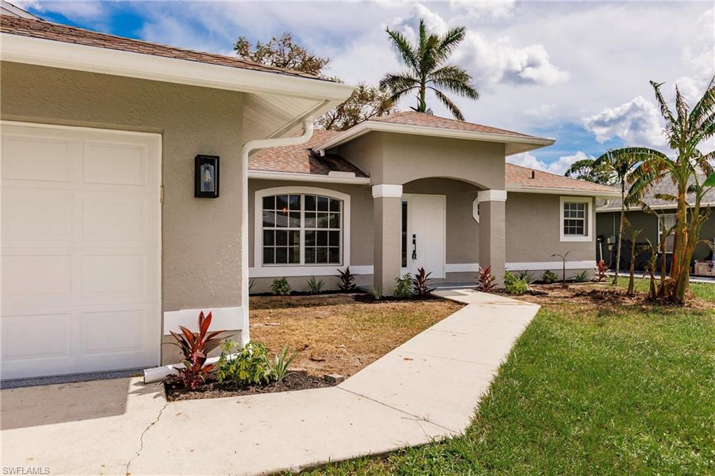 18289 Hepatica Road Fort Myers, FL 33967 - Photo 3 of 45 a front view of a house with yard and parking