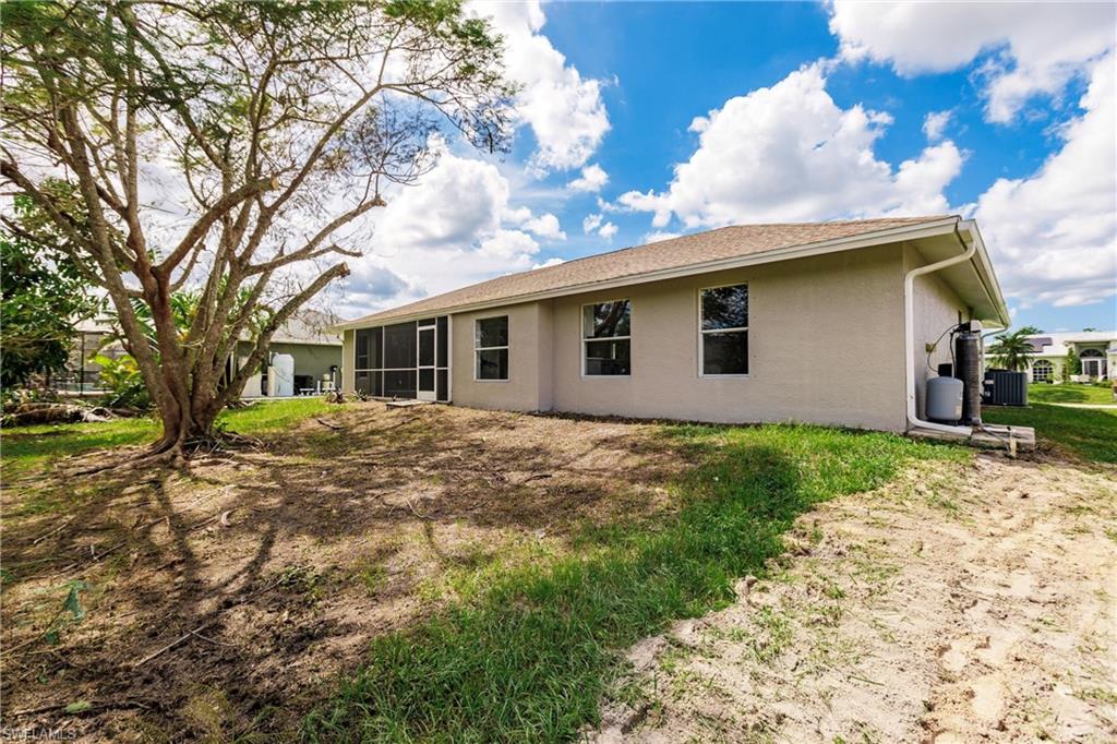 18289 Hepatica Road Fort Myers, FL 33967 - Photo 44 of 45 a backyard of a house with large trees and barbeque oven