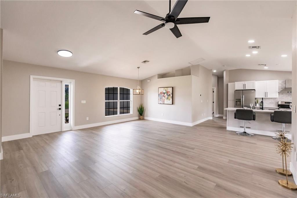 18289 Hepatica Road Fort Myers, FL 33967 - Photo 7 of 45 a view of a living room a kitchen and a wooden floor