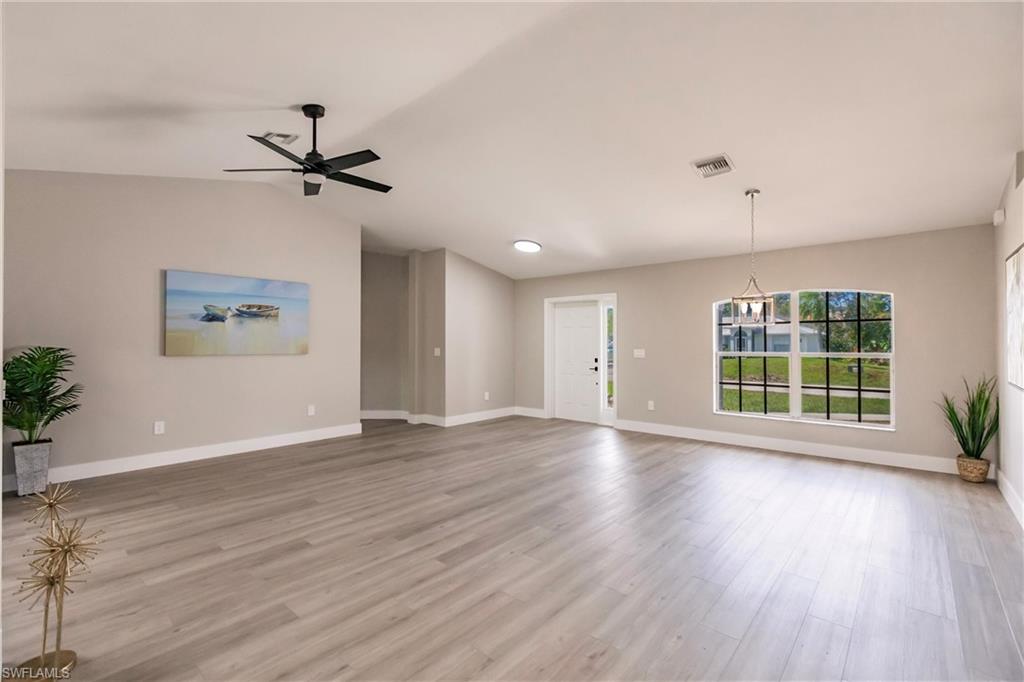 18289 Hepatica Road Fort Myers, FL 33967 - Photo 8 of 45 a view of an empty room with a window and wooden floor