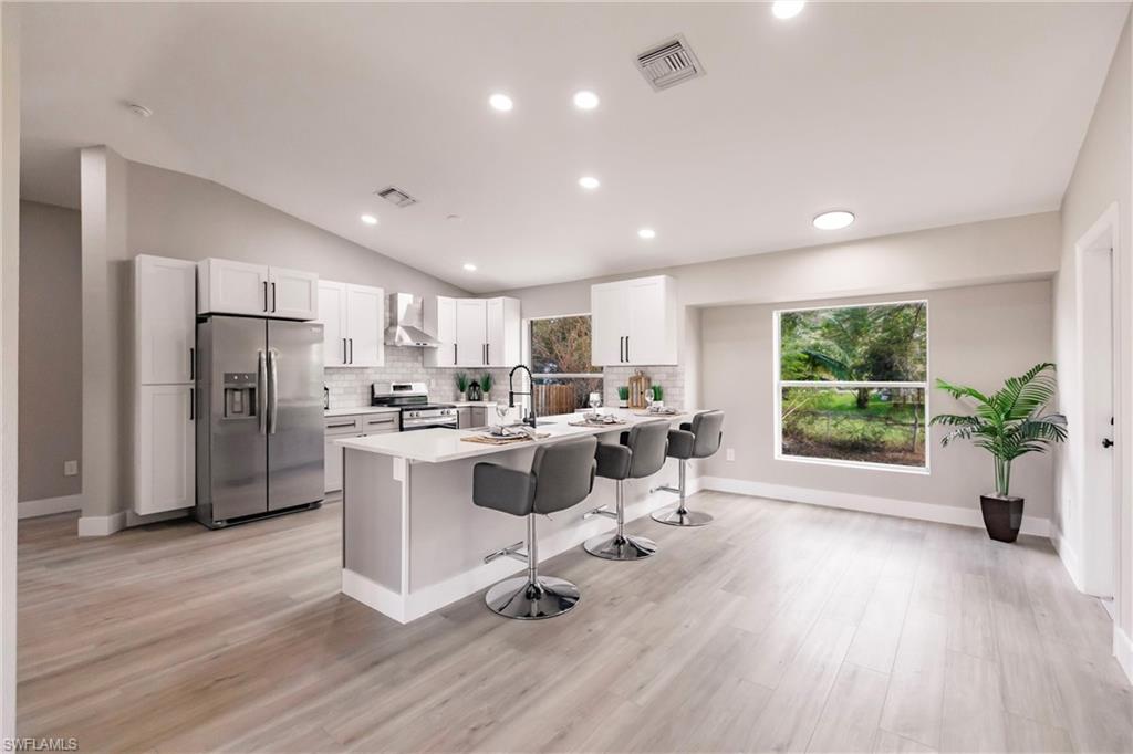 18289 Hepatica Road Fort Myers, FL 33967 - Photo 10 of 45 a view of a kitchen with furniture wooden floor and a window