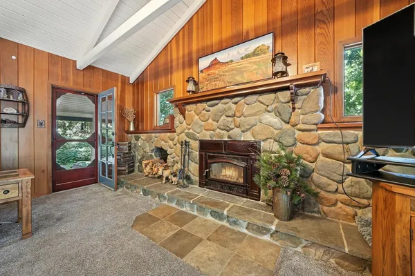 a kitchen with kitchen island a stove a sink a counter top space and cabinets