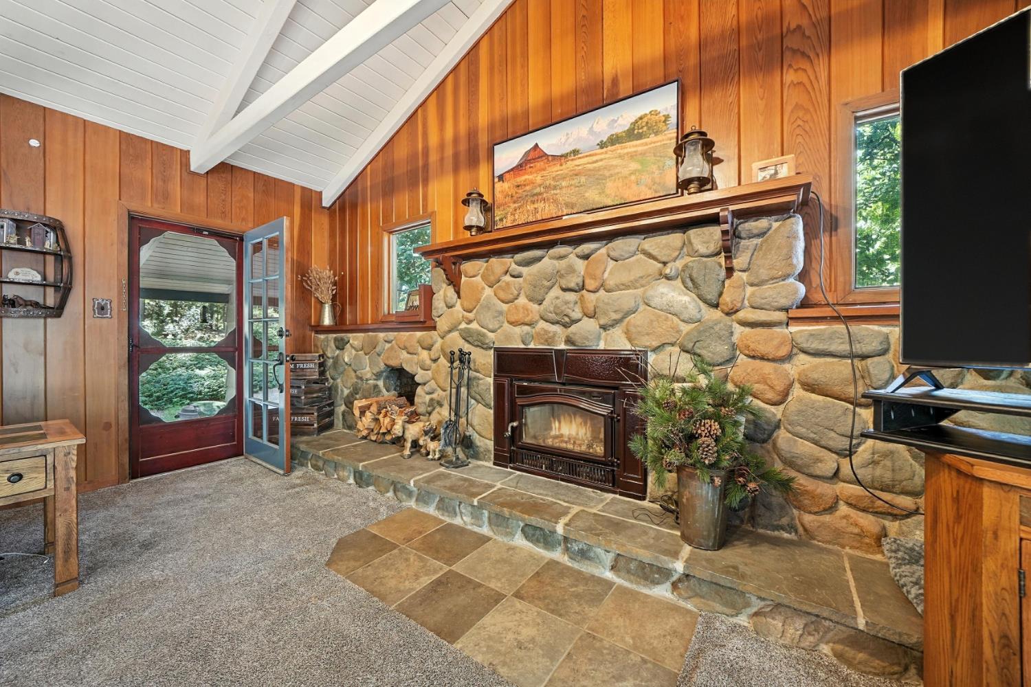 19630 Charleston Road Volcano, CA 95689 - Photo 14 of 70 a living room with furniture a flat screen tv and a fireplace