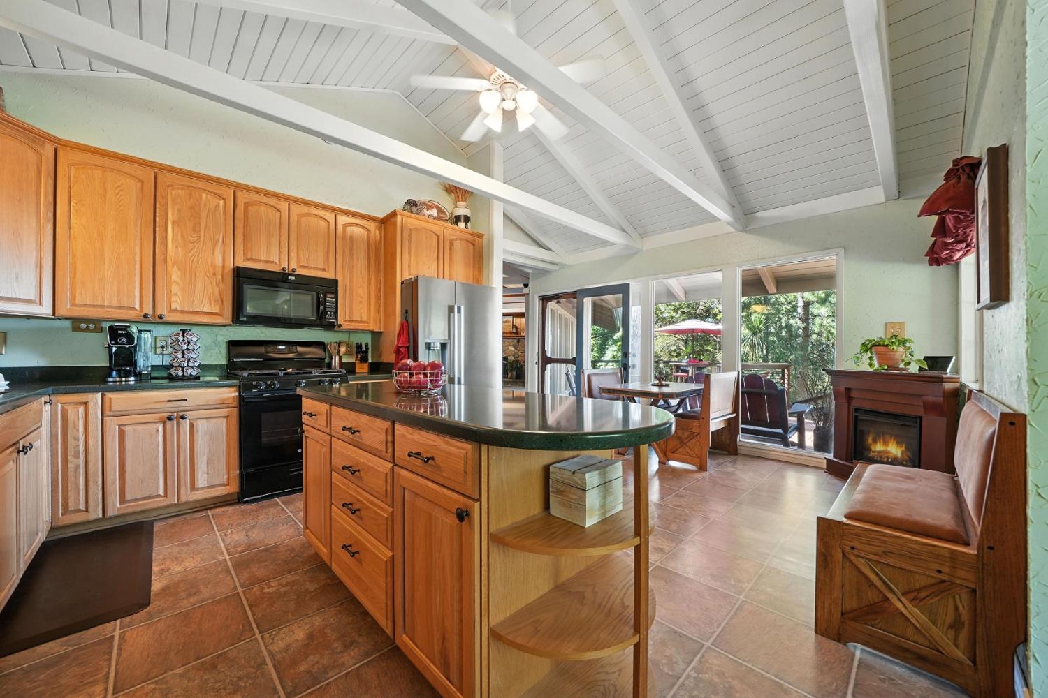 19630 Charleston Road Volcano, CA 95689 - Photo 24 of 70 a kitchen with stainless steel appliances granite countertop a stove a sink dishwasher a dining table and chairs with wooden floor