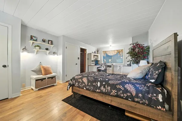 a view of a hallway with furniture and window