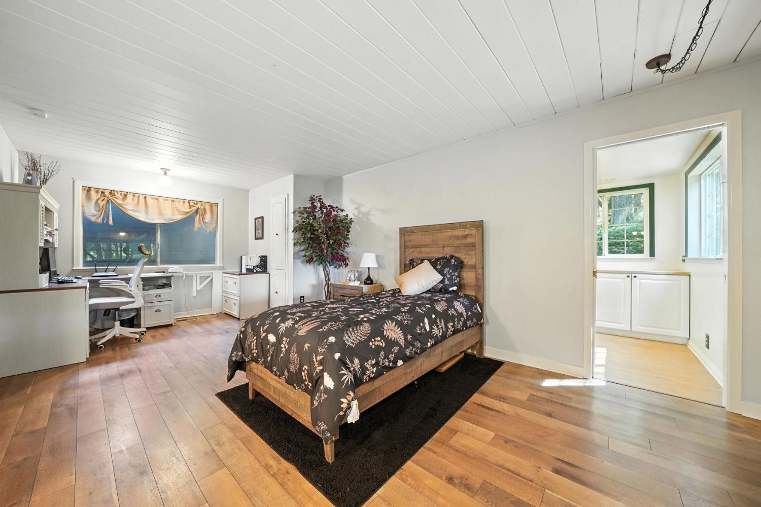 19630 Charleston Road Volcano, CA 95689 - Photo 26 of 70 a bedroom with a bed a mirror and window