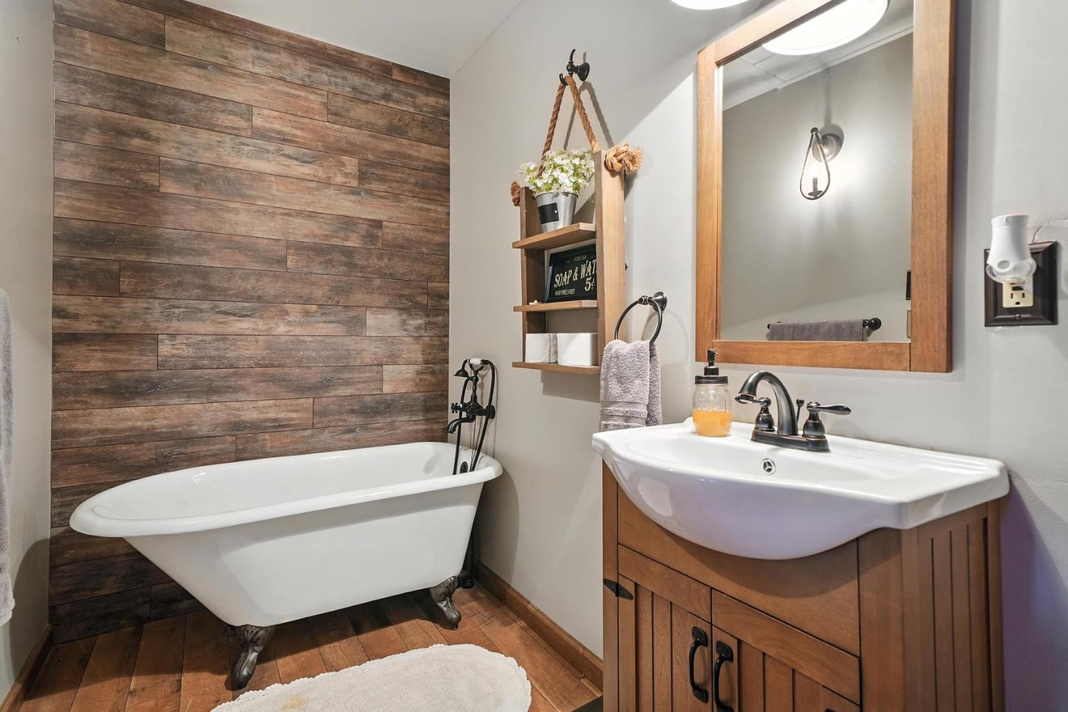 19630 Charleston Road Volcano, CA 95689 - Photo 28 of 70 a bathroom with a sink a toilet a mirror and bathtub