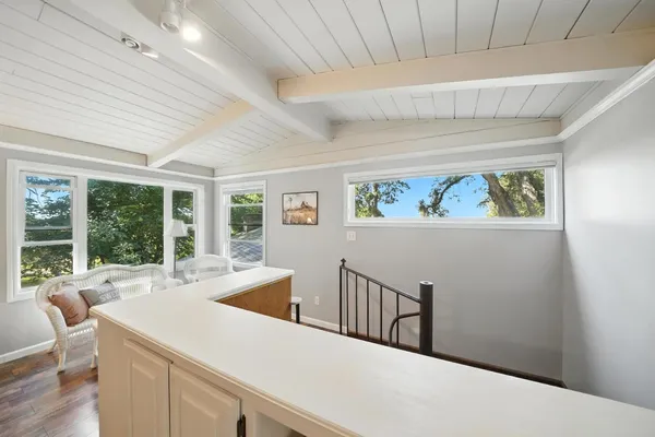 a bathroom with a toilet a sink a mirror and shower