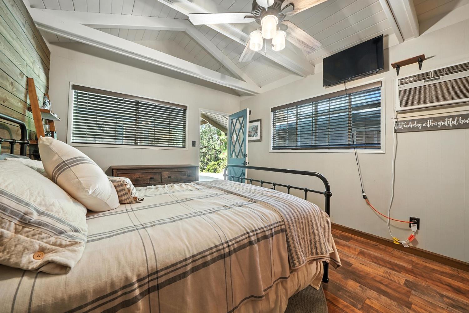 19630 Charleston Road Volcano, CA 95689 - Photo 53 of 70 a bedroom with a bed next to a window with a chandelier