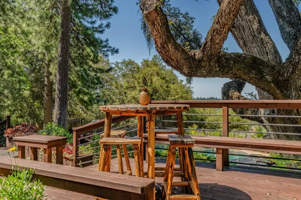 a view of a house with a yard and sitting area