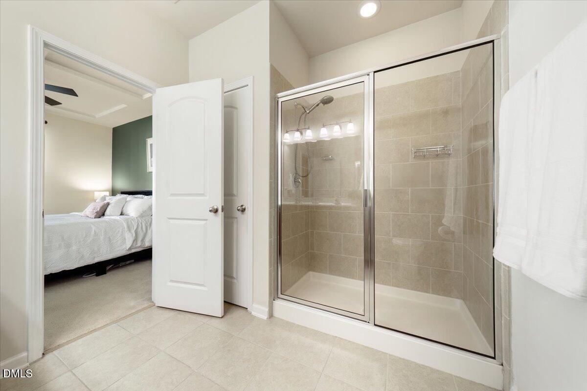 7328 Caversham Way Raleigh, NC 27617 - Photo 18 of 35 a bathroom with a glass shower door and a sink