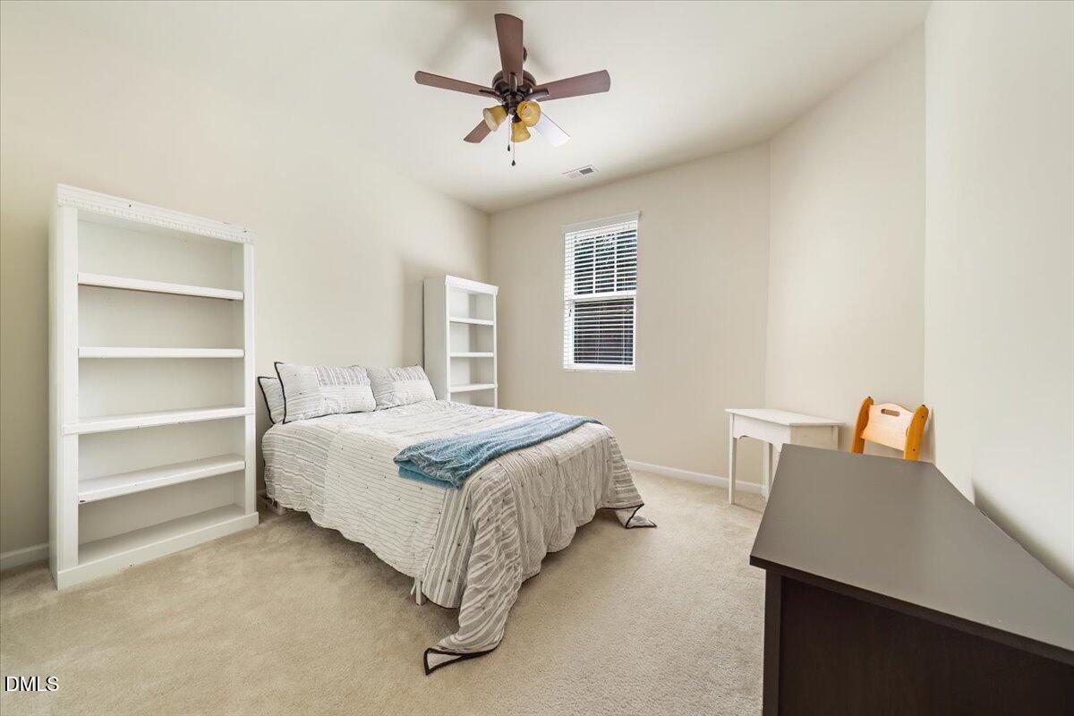 7328 Caversham Way Raleigh, NC 27617 - Photo 22 of 35 a bedroom with a bed and a desk