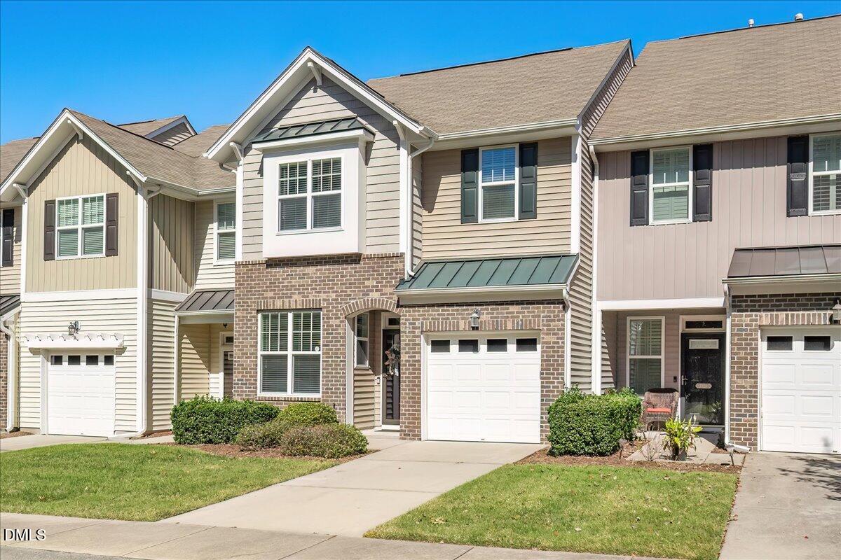 7328 Caversham Way Raleigh, NC 27617 - Photo 2 of 35 a front view of a house with a yard and plants