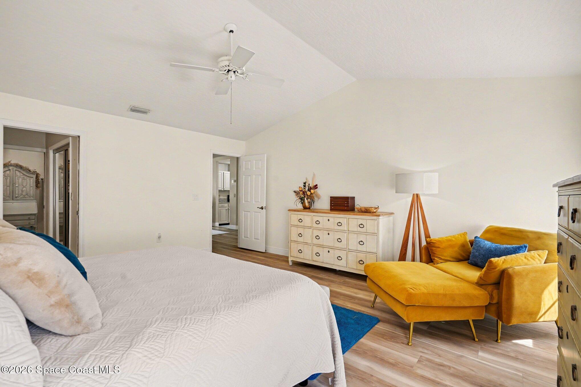 873 Ridge Lake Drive Melbourne, FL 32940 - Photo 13 of 27 a bedroom with 2 bed and a chandelier