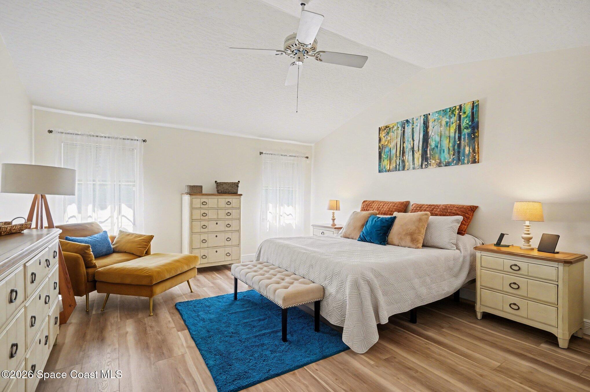873 Ridge Lake Drive Melbourne, FL 32940 - Photo 14 of 27 a bedroom with a bed and wooden floor