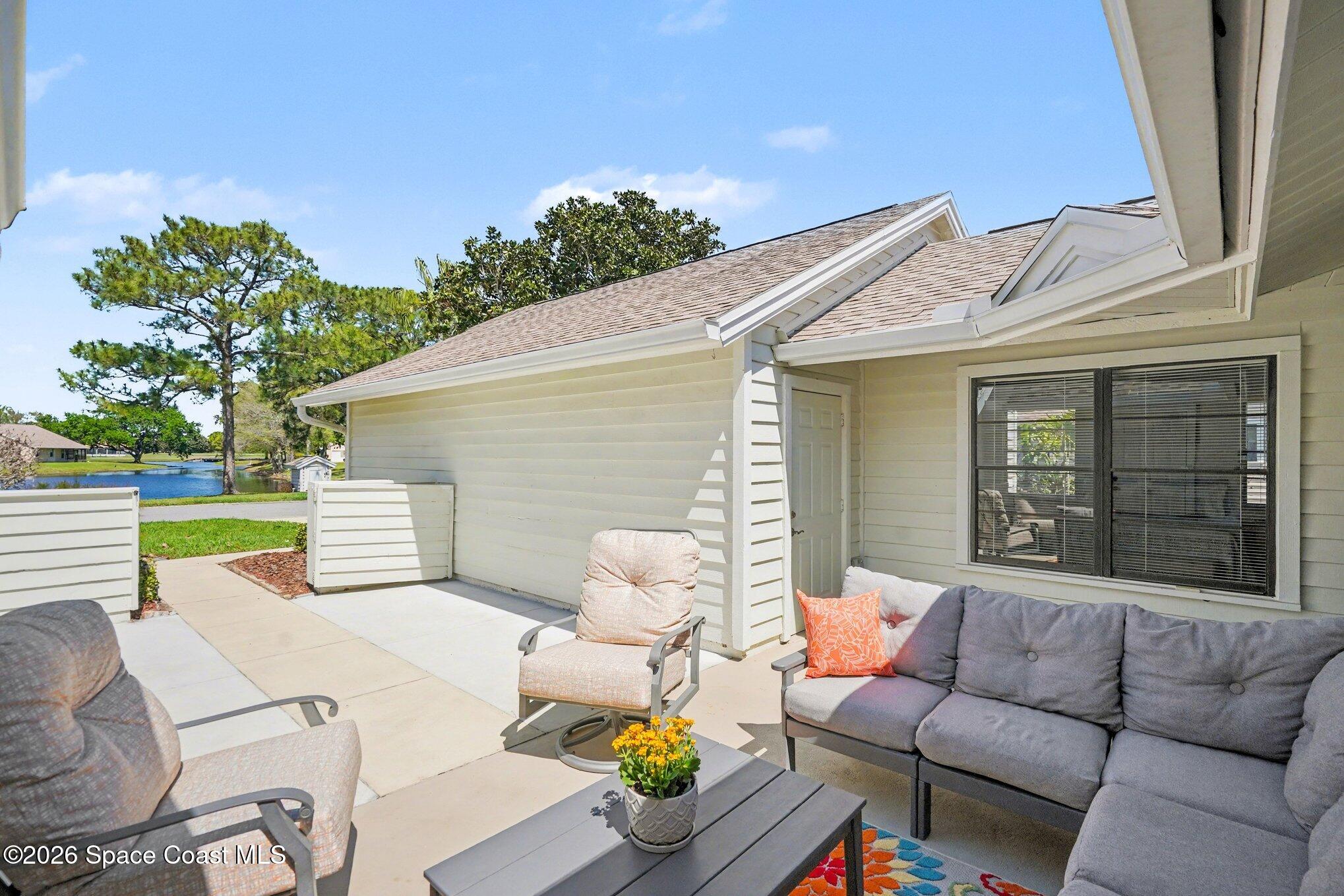 873 Ridge Lake Drive Melbourne, FL 32940 - Photo 3 of 27 a view of a patio with couches table and chairs with wooden fence