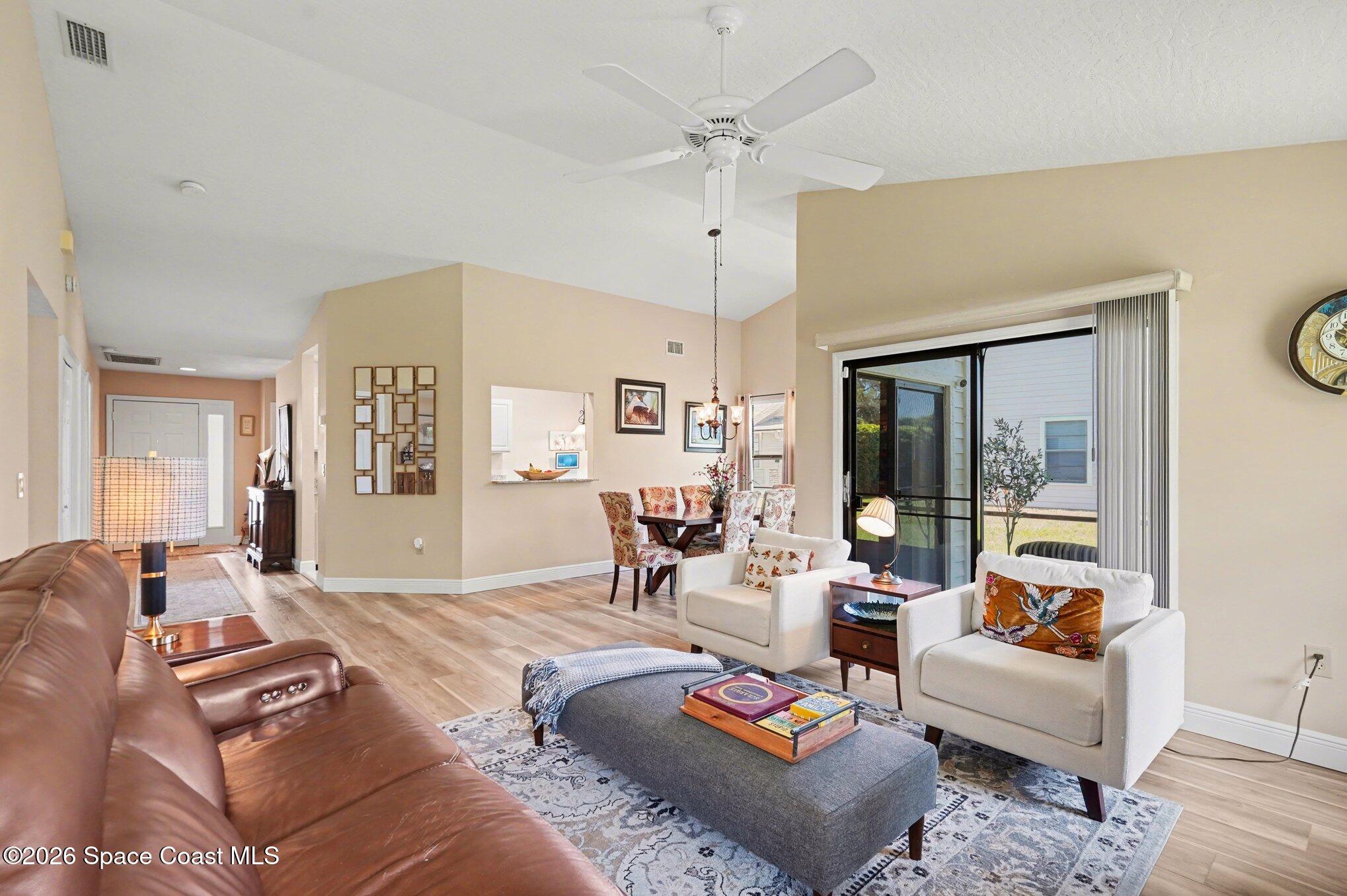 873 Ridge Lake Drive Melbourne, FL 32940 - Photo 4 of 27 a living room with furniture and a large window