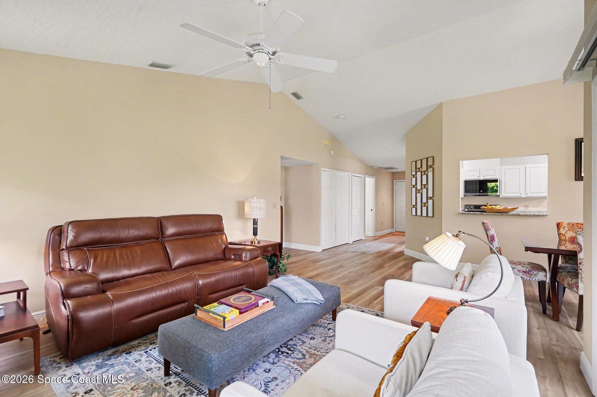 873 Ridge Lake Drive Melbourne, FL 32940 - Photo 5 of 27 a living room with furniture and wooden floor