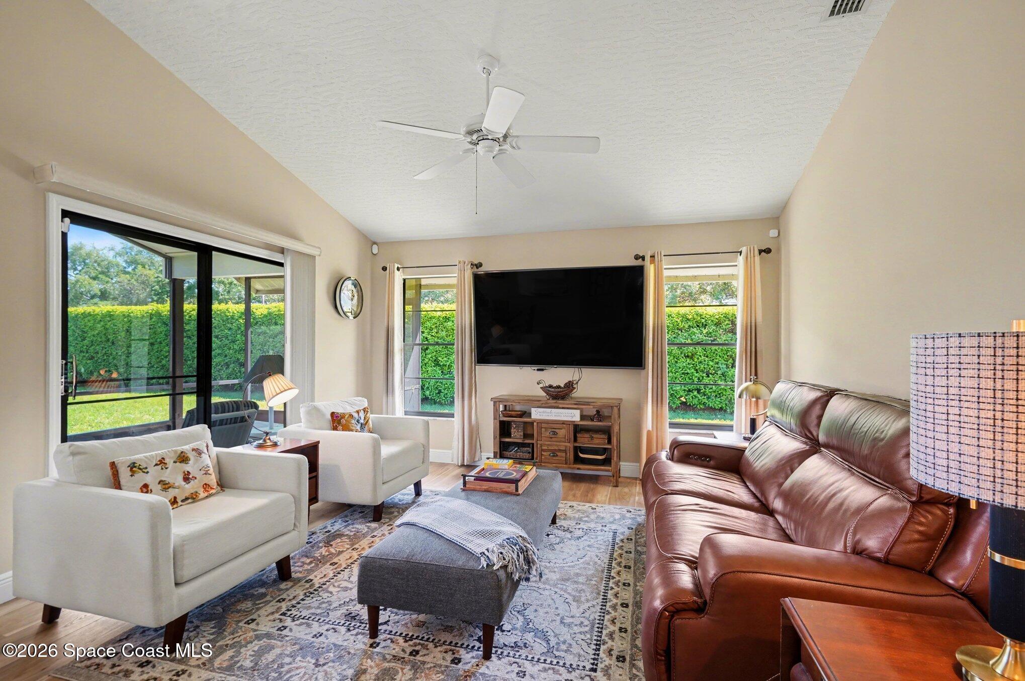 873 Ridge Lake Drive Melbourne, FL 32940 - Photo 6 of 27 a living room with furniture fireplace and a flat screen tv