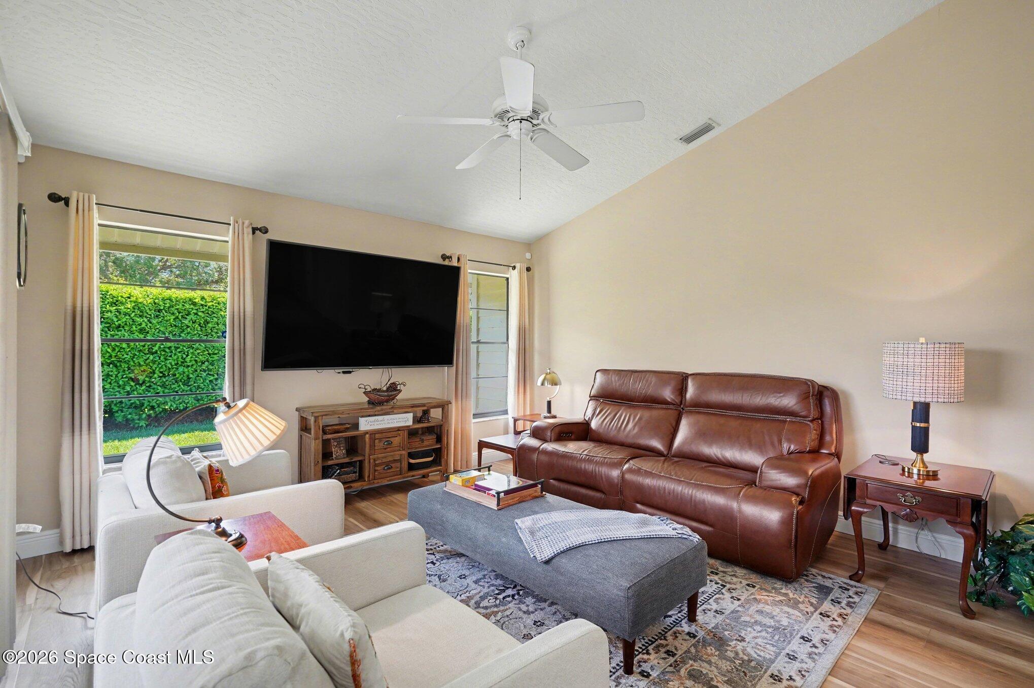873 Ridge Lake Drive Melbourne, FL 32940 - Photo 7 of 27 a living room with furniture and a flat screen tv