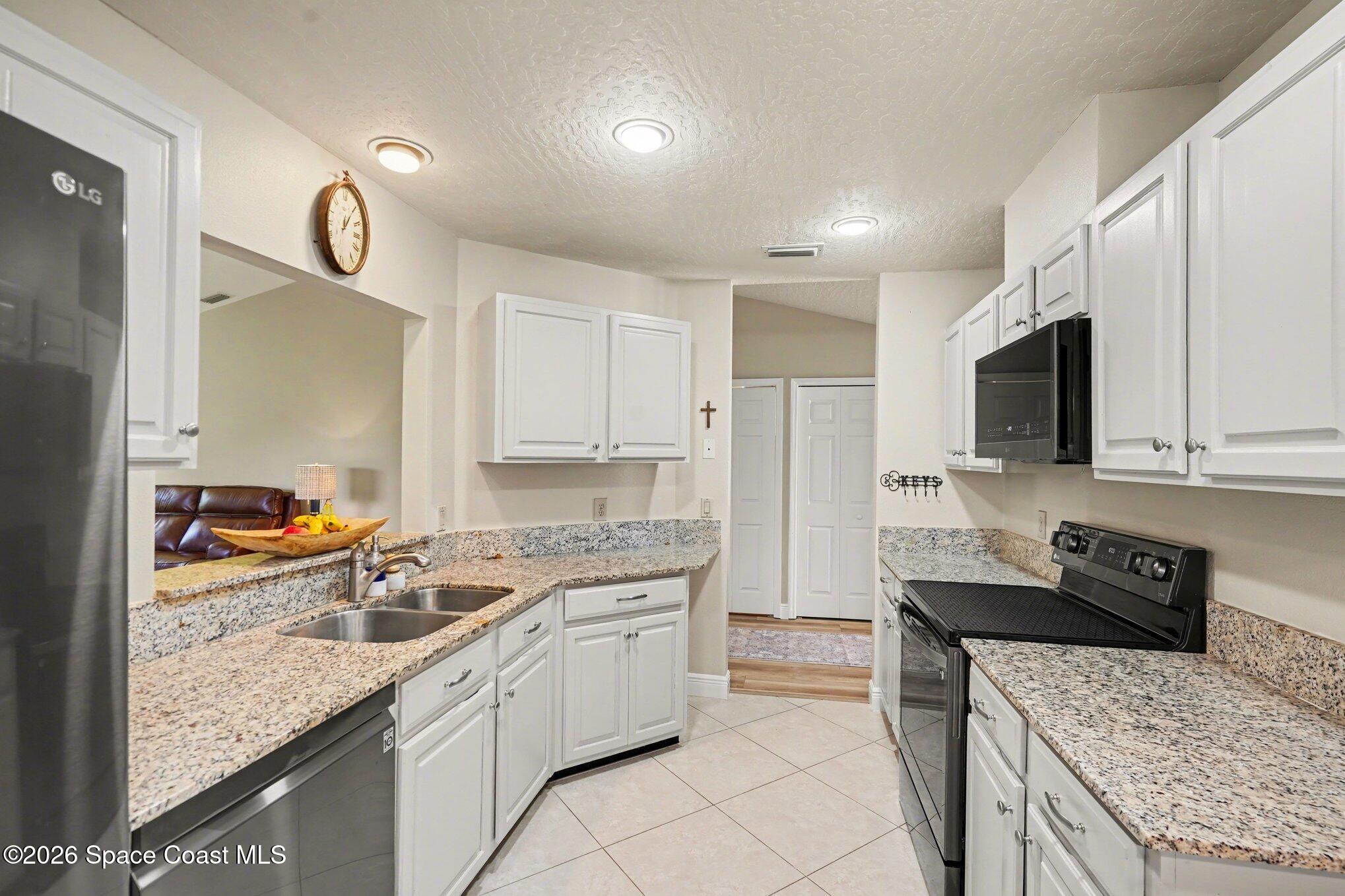 873 Ridge Lake Drive Melbourne, FL 32940 - Photo 10 of 27 a kitchen with a sink a stove and cabinets