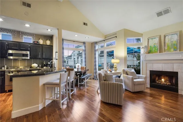 a living room with furniture wooden floor and a fireplace