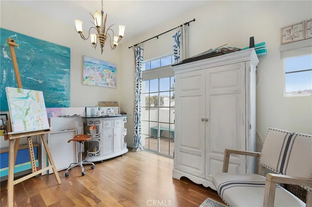 a view of a workspace with furniture and chandelier
