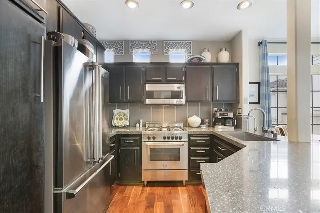 a kitchen with a refrigerator stove and sink