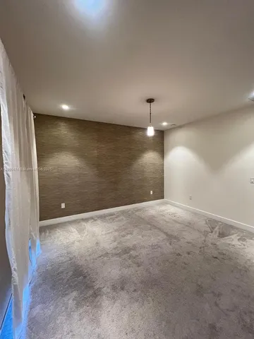 wooden floor in an empty room with a bathroom