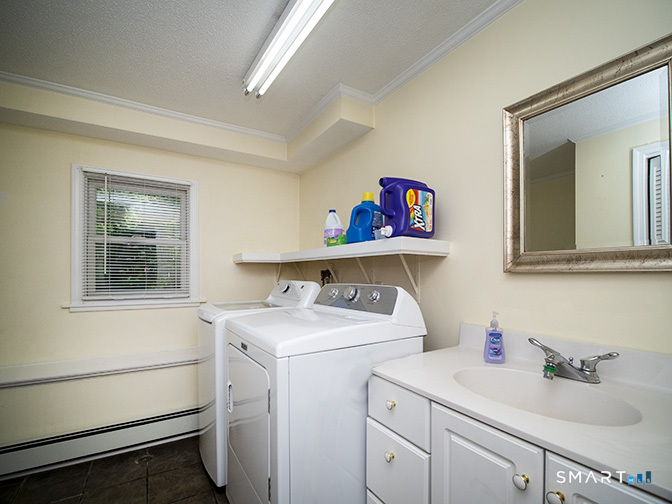 82 Wilcox Road Middletown, CT 06457 - Photo 24 of 27 a utility room with sink dryer and washer